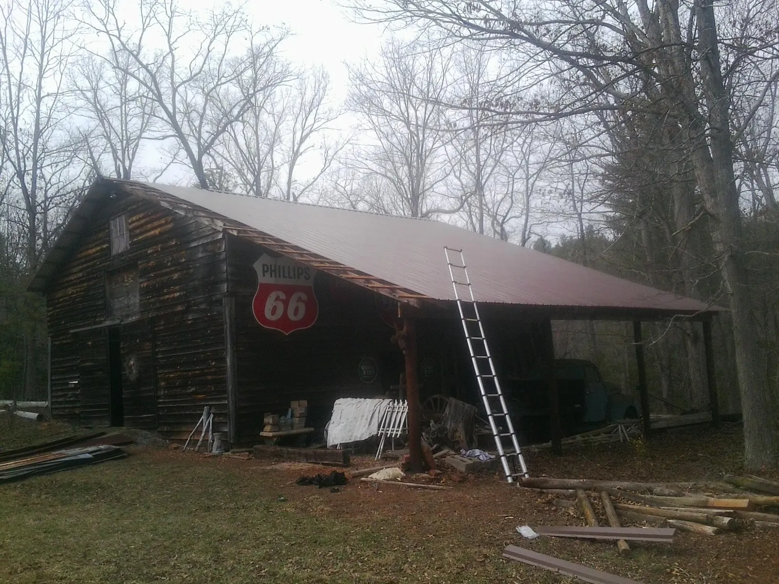 New metal roof on an open sided timber barn with a vintage sign in Middletown