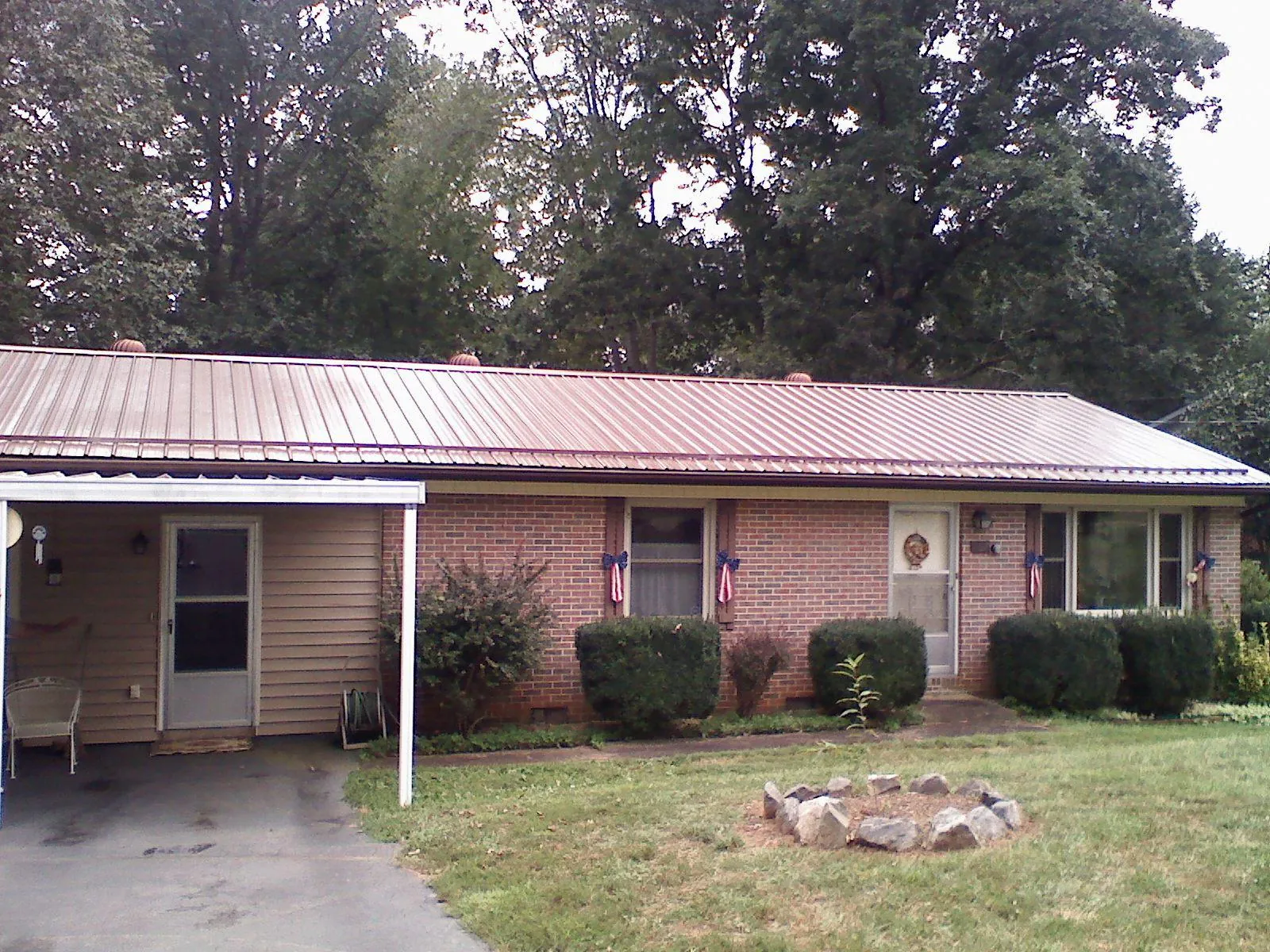 Bronze metal roof and carport on a brick ranch home — Roof Repair work by our crew in Middletown